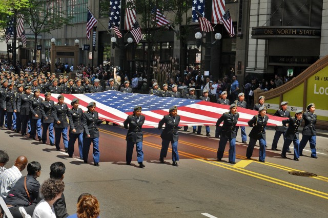 JROTC cadets march presenting the American flag in Chicago
