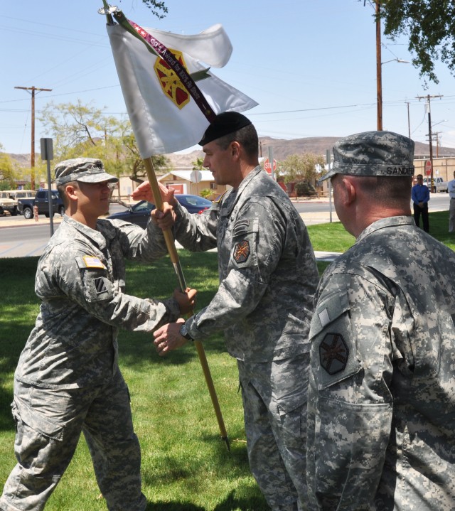 Cpt. Lenart returns the company guidon to Fort Irwin garrison commander Col. Jon Braga
