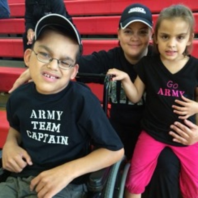 Honorary Team Army Captain Oren Lara, his mom Catrin and his sister Leonie cheer on Team Army 