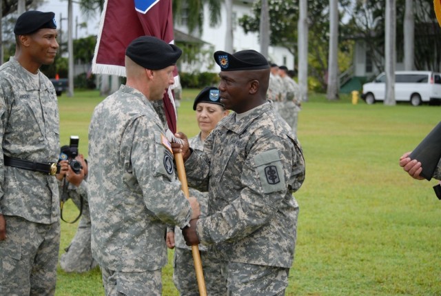 Command Sgt. Major Wrighton passes Col. Ackermann the colors