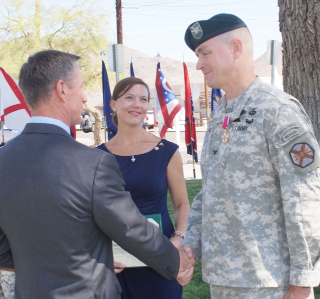 Col. Braga is congratulated for his achievements as Fort Irwin garrison commander