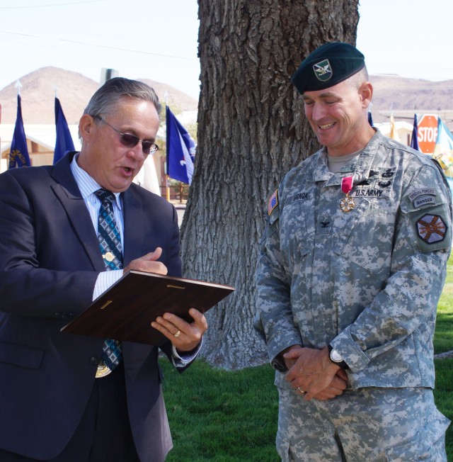 Barstow City Council's Merrill Gracey presents Col. Braga with council proclamation