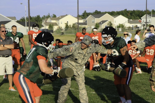 Orange football players face off in pugil stick bout