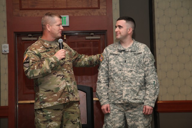 Sgt. Maj. Michael Hatfield congratulates 1st Lt. Michael Piscetelli 