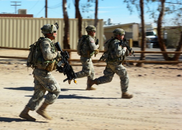 Soldiers of 1st Armored Brigade Combat Team, 1st Cavalry Division run to pull security