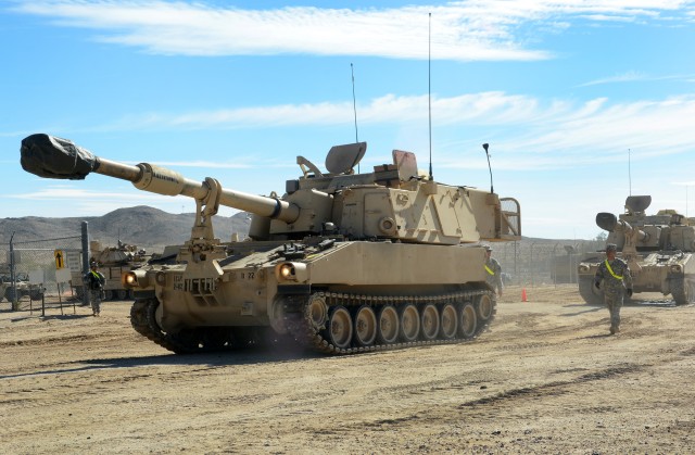 M109 self-propelled howitzers on the move at the National Training Center