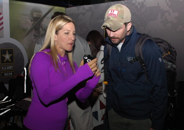 Stephanie shows Teschner photos at the Army Ten-Miler Expo