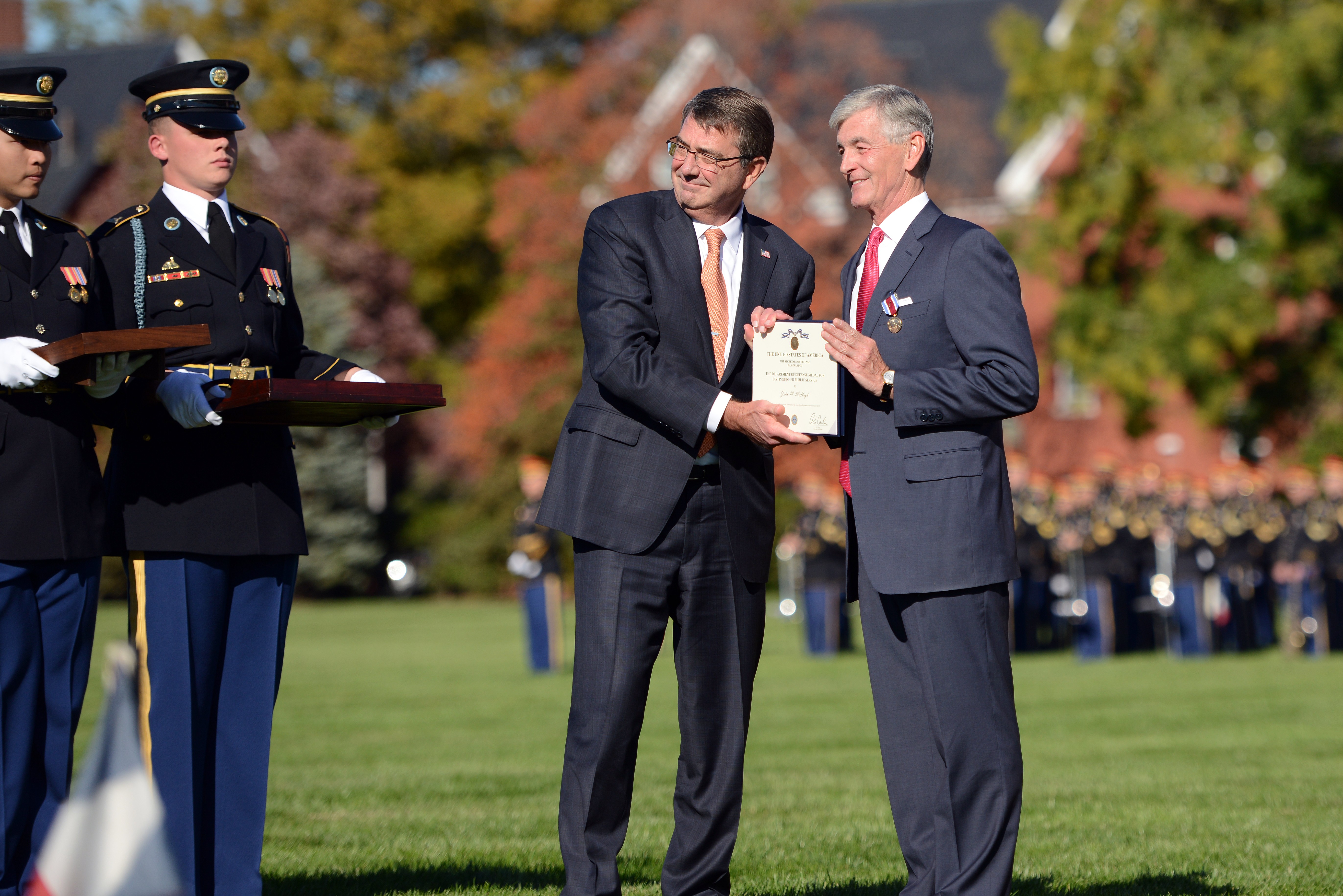 Secretary of Defense Ash Carter steadies his hand using the