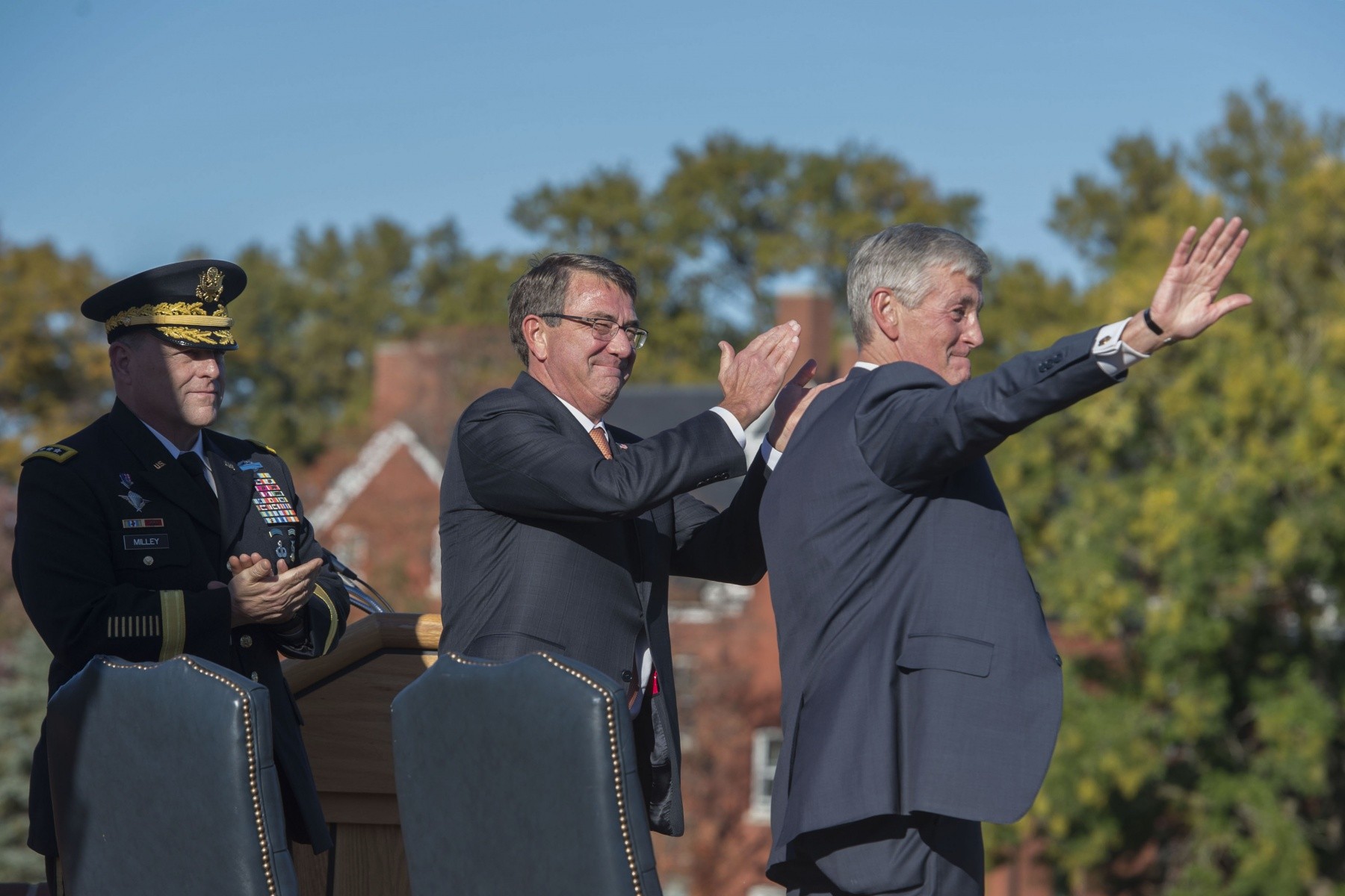 Secretary of Defense Ash Carter steadies his hand using the