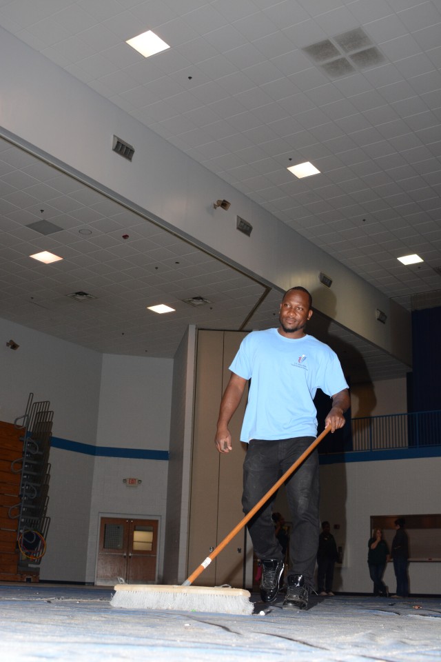 Darius Lane cleans up after the Fort Jackson Fall Festival
