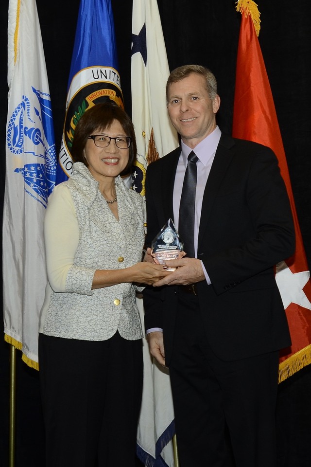 Ms. Shyu presents Aviation and Missile Research, Development and Engineering Center employee, Dan Bailey with the Science and Technology Professional of the Year award Dec. 1.