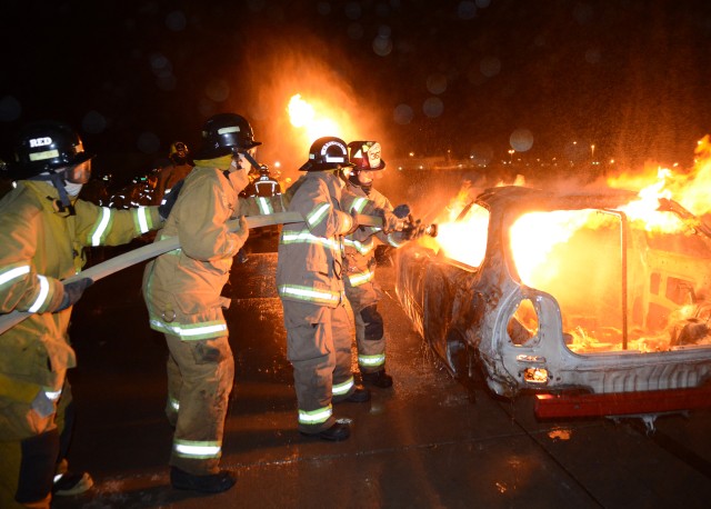 Barstow Fire Engine Capt. Jamie Williams (on nozzle) teaches fire attack on a vehicle
