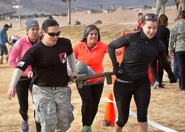 Military spouses compete in a litter carry