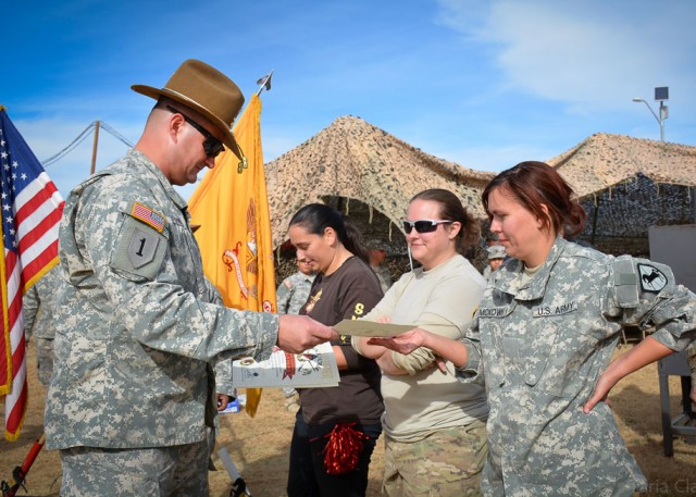 Lt. Col. James Stephens presents certificates to participants of the regiment's Spouses Spur Ride