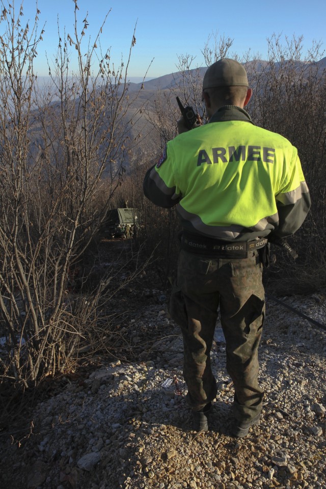 Multinational soldiers work together in vehicle recovery