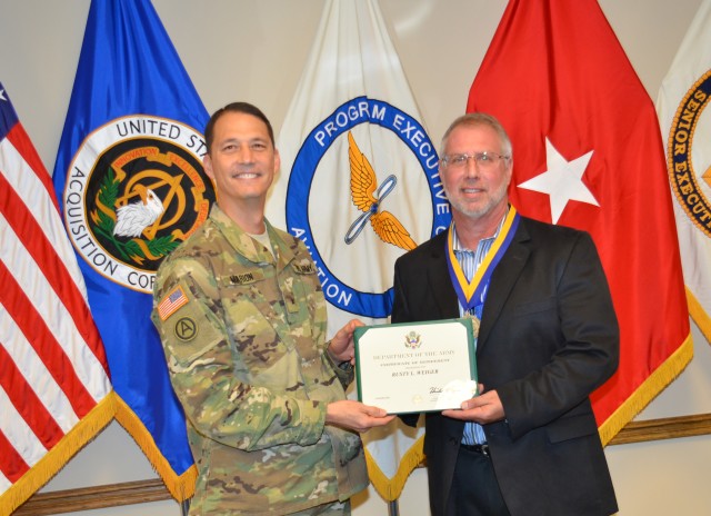 BG Marion presents Mr. Rusty Weiger with his certificate of retirement