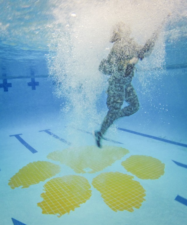 Female cadet swims for the pool side