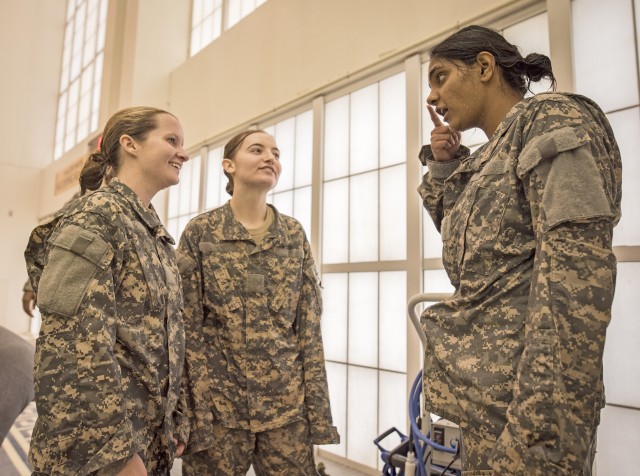 Female cadets share a wet laugh