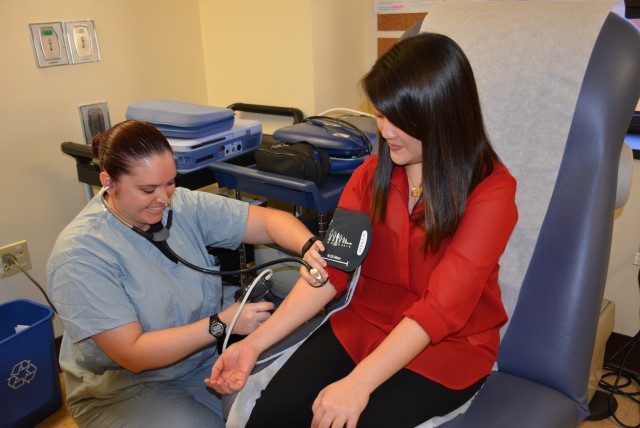 Patient having her blood pressure checked at TAMC