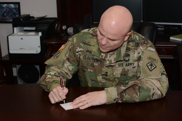 Maj. Gen. Cloutier signs his AER pledge form