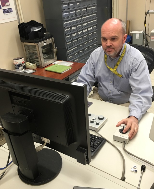 Dr. Kevin Minor, U.S Army Redstone Test Center Materials Engineer, performs analysis on an image generated by a scanning electron microscope.