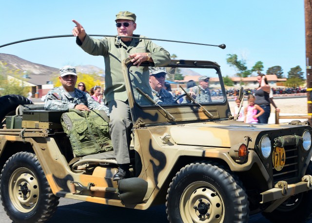 Vietnam War veteran waves to crowd at Fort Irwin parade honoring his service