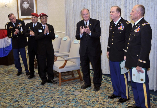 The Silver Star was awarded to Col. (Ret.) William Reeder Jr. (second from right) and Chief Warrant Officer 4 (Ret.) Daniel Jones (right) for bravery as Cobra helicopter pilots on April 14, 1972 in Vietnam. They attacked enemy forces that had a South Vietnamese battalion trapped, allowing survivors to escape. Among those survivors were, from left, Maj. (Ret.) John Duffy and former South Vietnamese Army officers Lt. Col. Li Van Me and Maj. Hai Phuong Doan. Congressman Sam Farr of California’s 20th district (center) presented the Silver Stars.