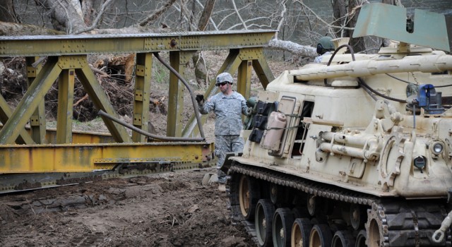 Engineers dismantle bridge toppled by flood