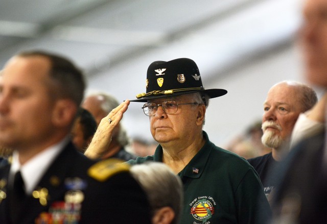 A Vietnam War era Veteran salutes during the national anthem
