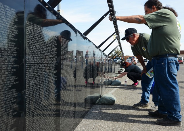 Vietnam War Veterans, of the group Vietnam Veterans Ventura County, look at names on