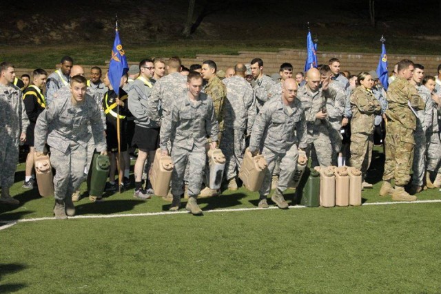 Airman carring water jugs