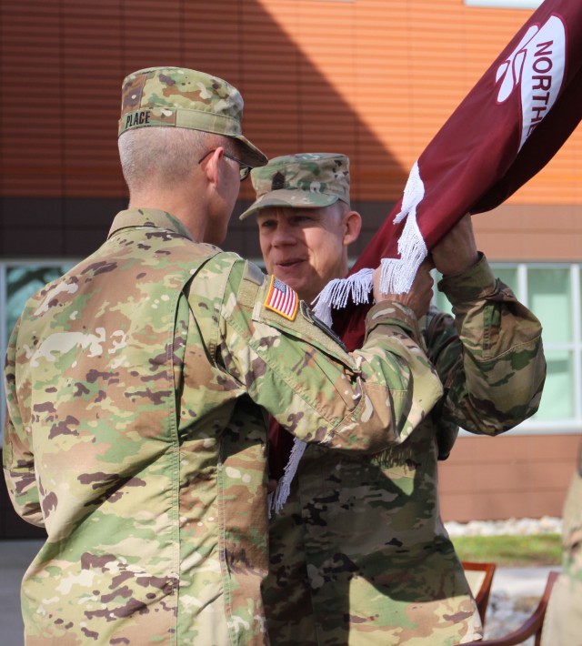 Command Sgt. Maj. Matthew Brady accepts the Regional Health Command-Atlantic organizational colors from Brig. Gen. Ronald J. Place during a Change of Responsibility ceremony, April 19 at the Regional