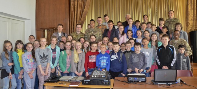 Ukrainian school children and civil affairs Soldiers pose for a group photo