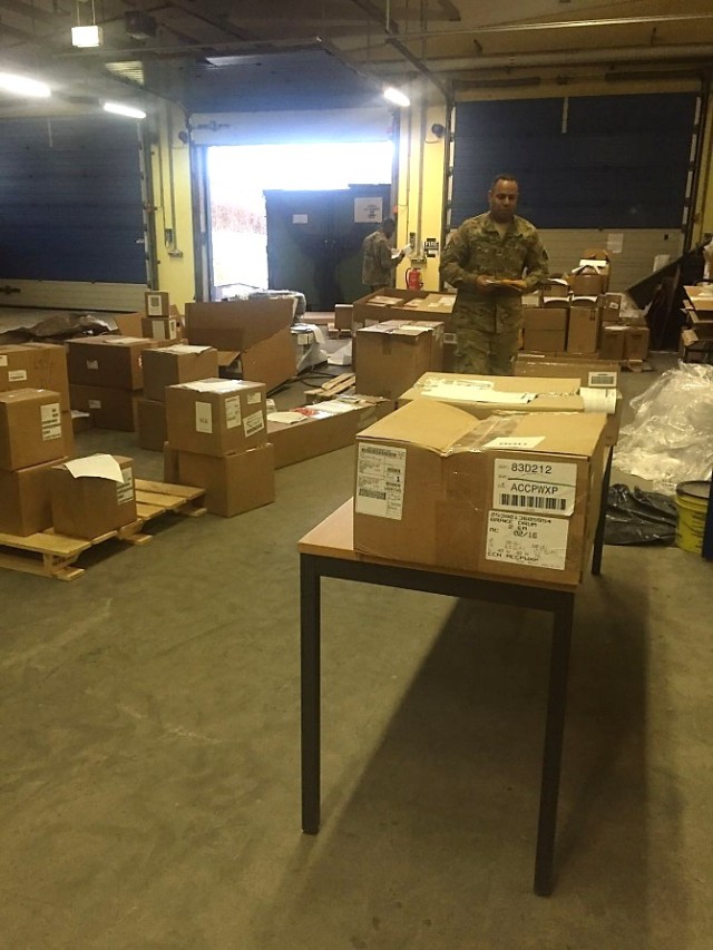 Sergeant Hilario, Staff Sergeant Tse and Specialist Binge receive a delivery.