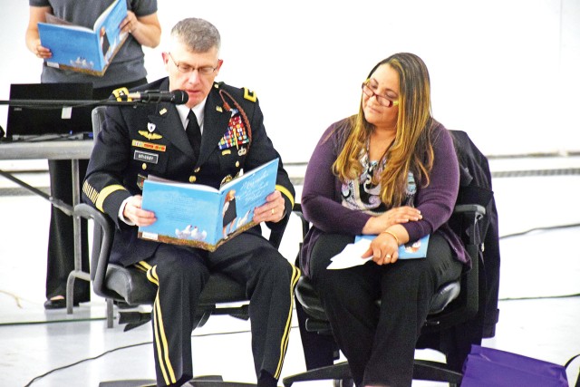 Maj. Gen. Wayne W. Grigsby Jr., commanding general of the 1st Infantry Division and Fort Riley tells a story to military children