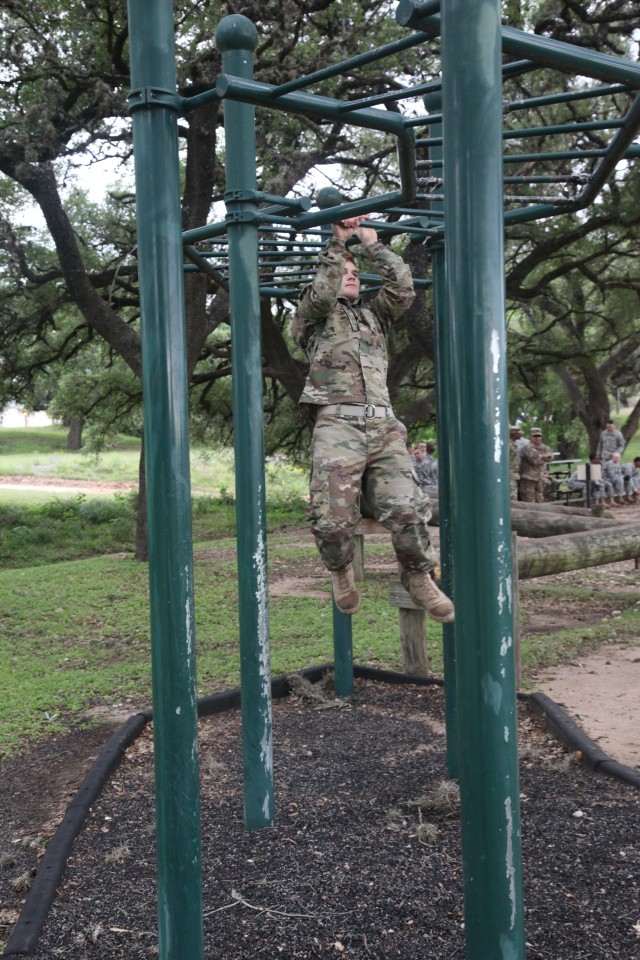 Sgt. Adams climbs the monkey bars