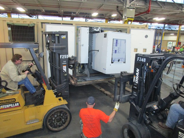 Two fork trucks and a machine