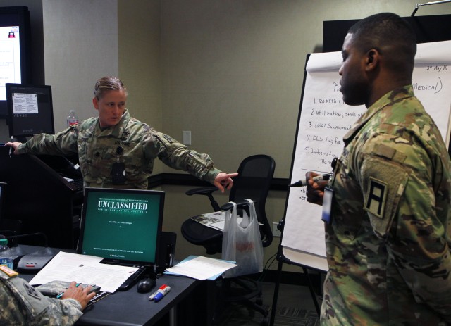 Lt. Col. Jennifer Cradier, First Army's chief medical operations officer (left) points out a recommendation in an open forum during First Army's first medical and clinical operations summit at the Fir