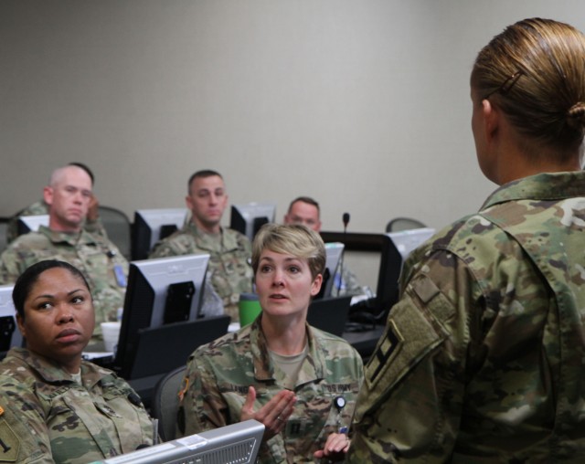 U.S. Army Capt. Brandi Lange (middle), a medical operations officer assigned to the 120th Infantry Brigade out of Fort Hood, Texas, discusses her recommendation during an open forum at the First Army'