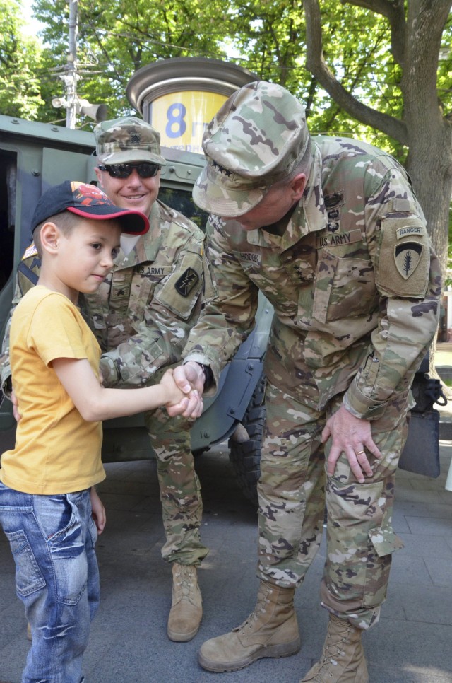 Lt. Gen Ben Hodges greets Ukrainian a Ukrainian boy as part of the America Days festival