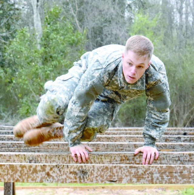 Sgt. Ian Ramsey hurdles a barrier during the 2016 Army Best Warrior comptetition
