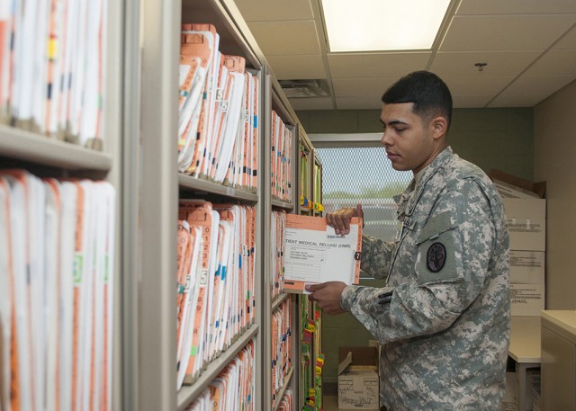 Pvt. Kendric Smith files medical records at Guthrie Ambulatory Healthcare Clinic