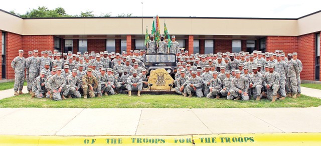 Soldiers of the 97th Military Police Battalion at Fort Riley stand outside the Battalion Headquarters