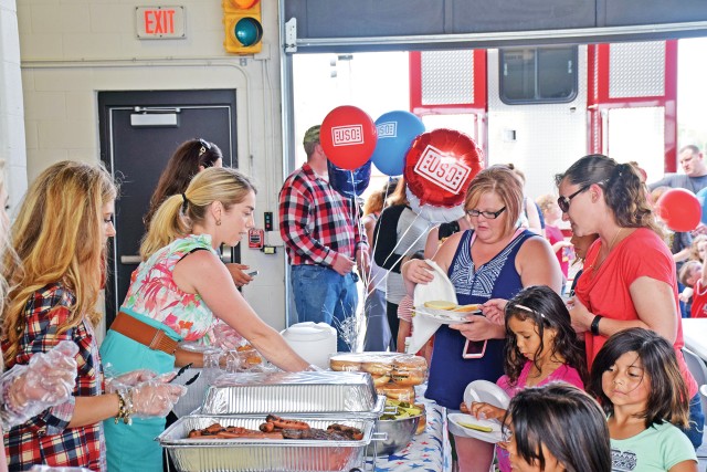 Guests wait to celebrate USO Fort Riley's birthday with a traditional No Dough Dinner -- hamburgers and hotdogs
