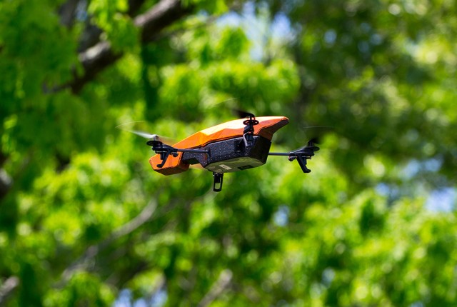A drone patrols the perimeter of a training village