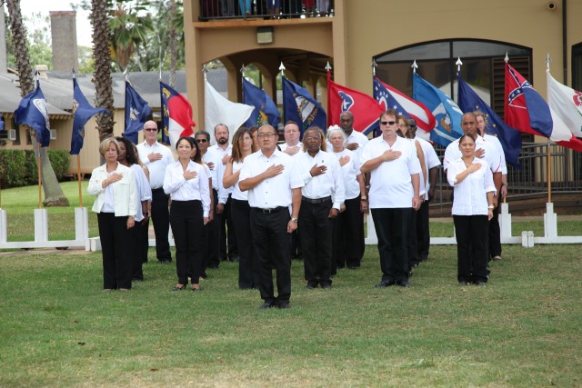 Soldiers and civilians assigned to U.S. Army Health Clinic - Schofield Barracks share the field during the change of command ceremony on June 23, 2016.