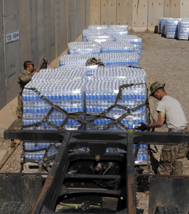 Soldiers in Iraq prepare water for transport
