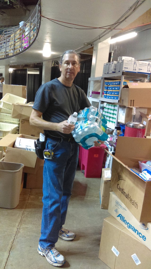 Corps worker distributes water for good cause