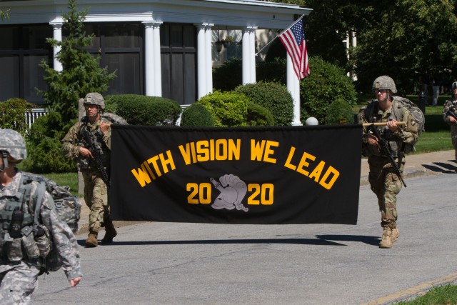 The Class of 2020&#8236; approaches the Academy with the banner displaying their class motto