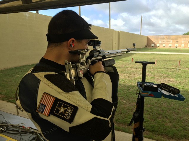 Spc. Dan Lowe aims his rifle down range